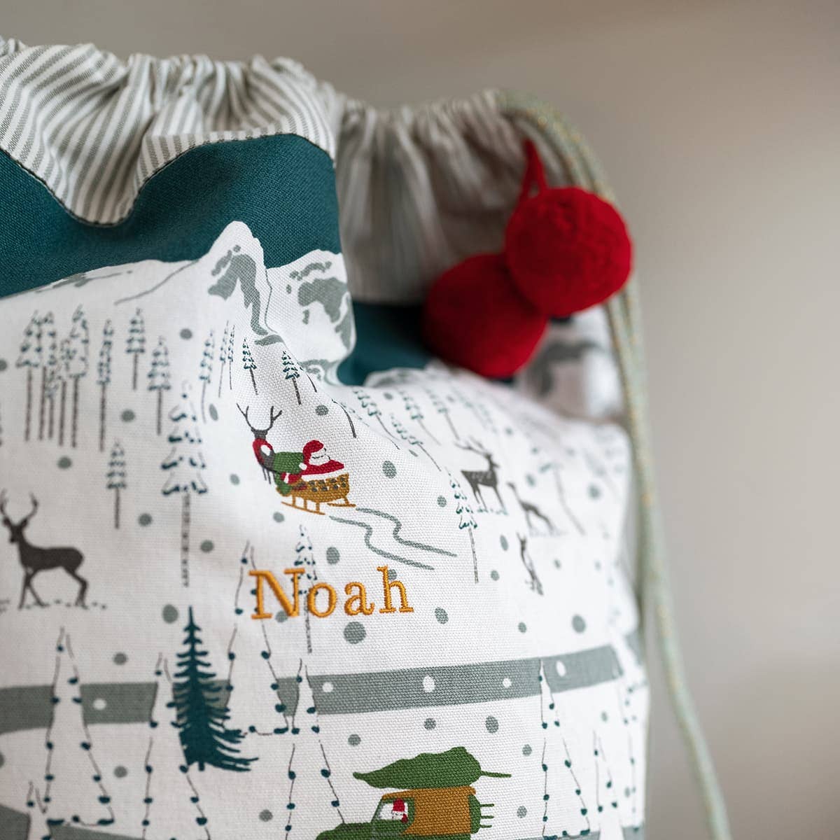 Children's bag with winter scene design and 'Noah' embroidery on a plain background