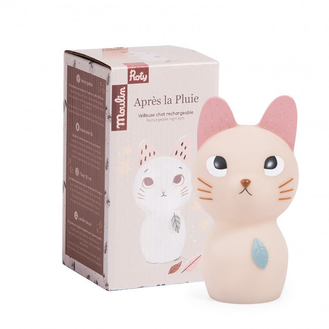 Cream cat night light with pink ears and blue leaf detail displayed beside its original Moulin Roty After the Rain Collection packaging.