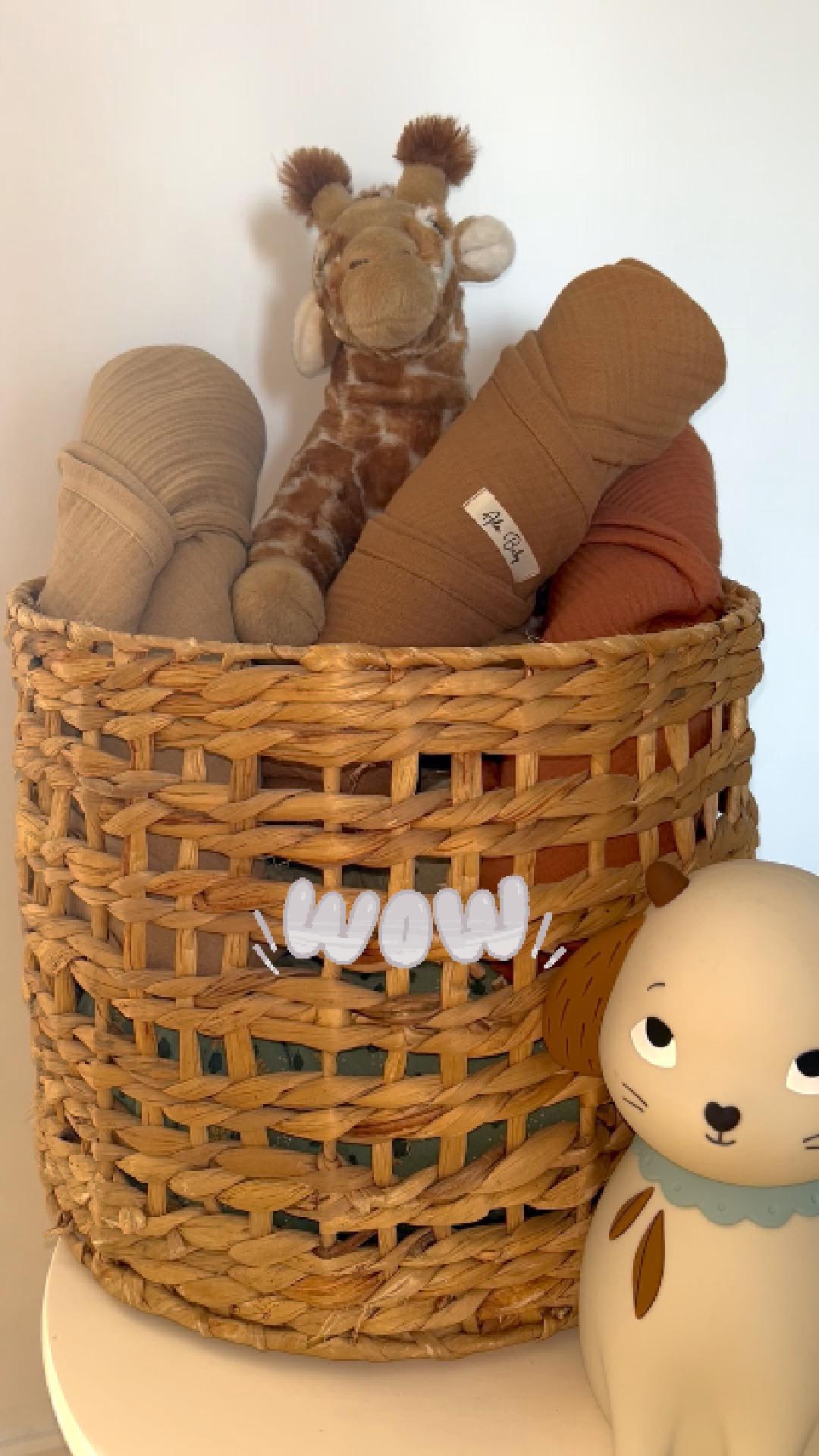 Cream sheep night light personalised with the name Darcey, displayed beside a woven basket of baby blankets.