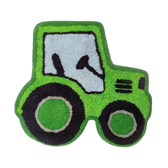 Bright green tractor-shaped rug with black wheels and grey cab on a white background