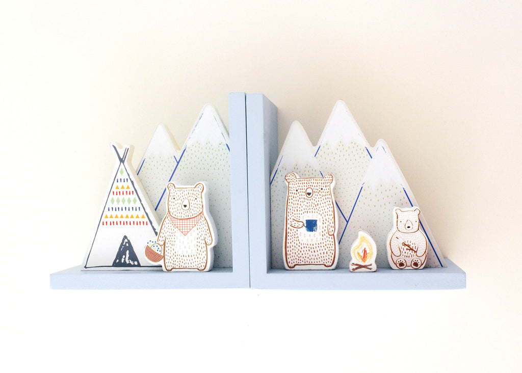 Camping bear bookends with mountain, tent and campfire illustrations on a white background