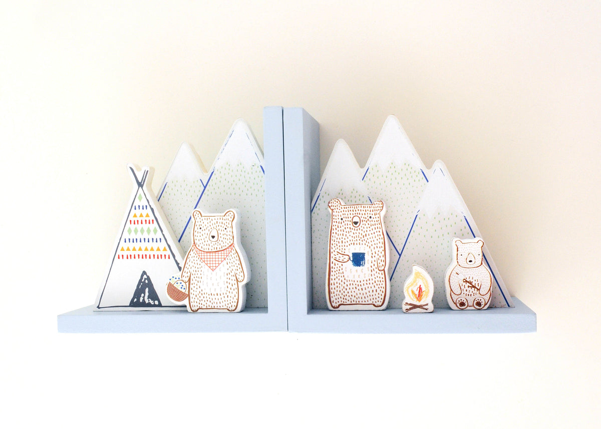 Camping bear bookends with mountain, tent and campfire illustrations on a white background