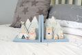 Camping bear bookends with illustrated bears, mountains, tents and campfire on a child’s bed