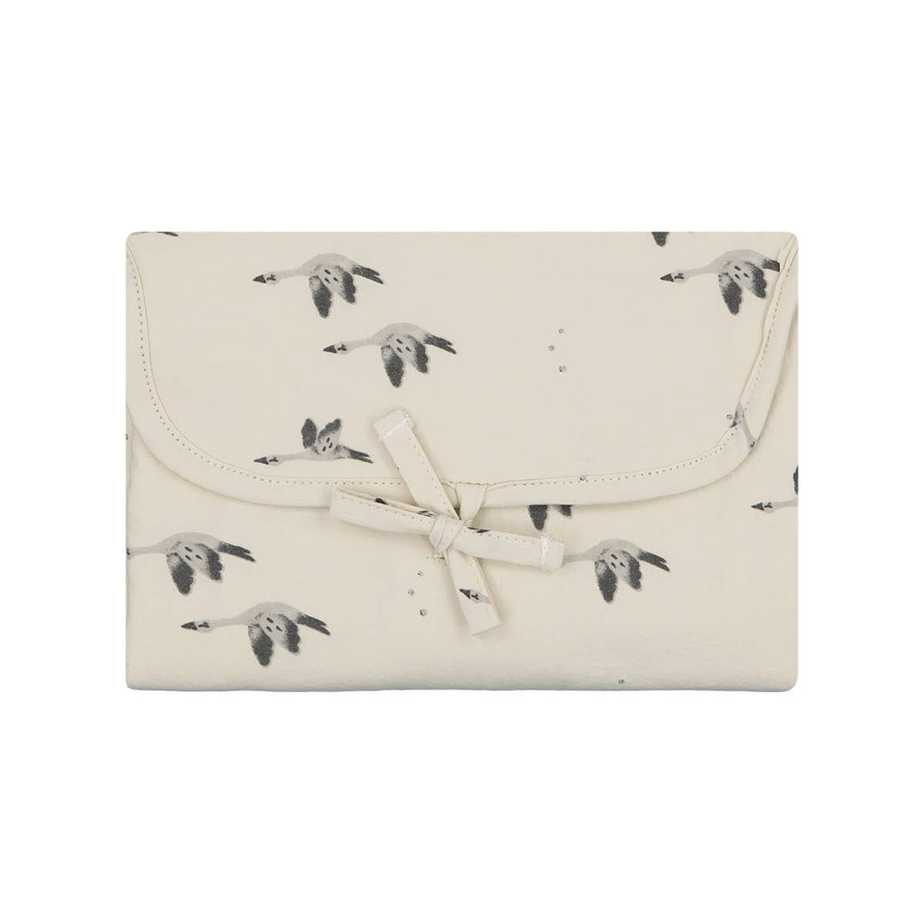 Folded Charly Goose changing mat in cream with a grey goose print and a matching fabric tie closure.