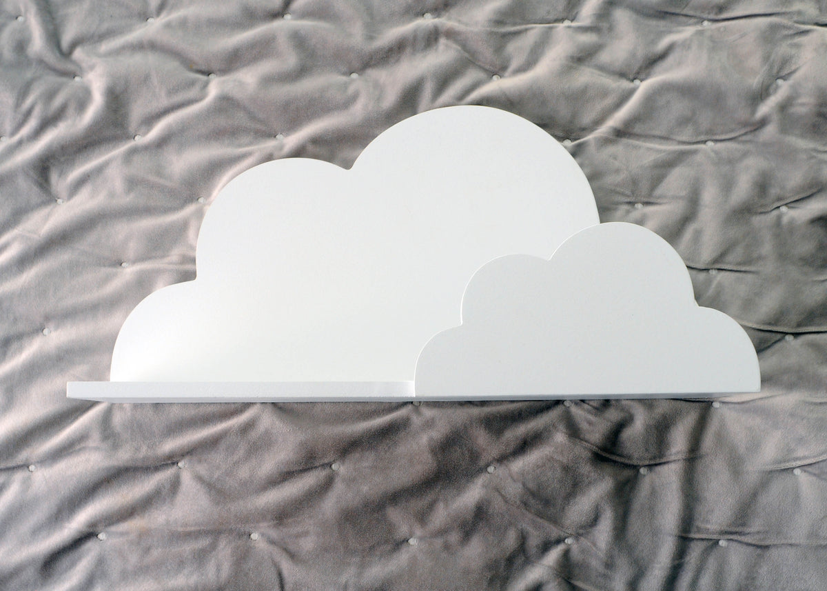 White cloud-shaped wall shelf displayed against a grey bedroom wall