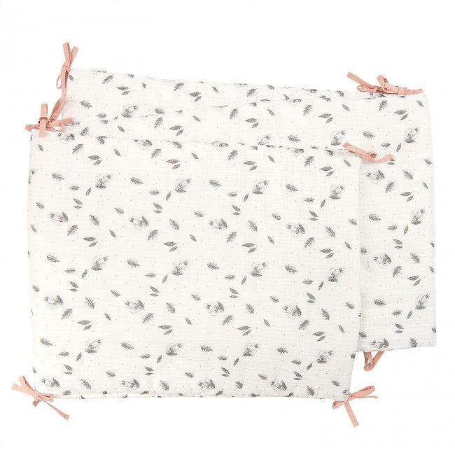 Cream After the Rain cot bumper laid flat, featuring a grey rabbit and autumn leaf pattern with pink fabric tie fastenings