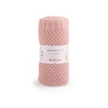 Dusky pink wool blend knitted baby blanket rolled and displayed in Moulin Roty packaging on a white background
