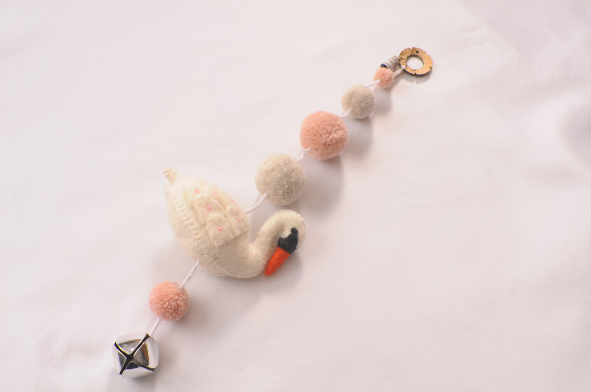 Handmade felt swan garland with pink and cream pom-poms, wooden hanging ring and silver bell