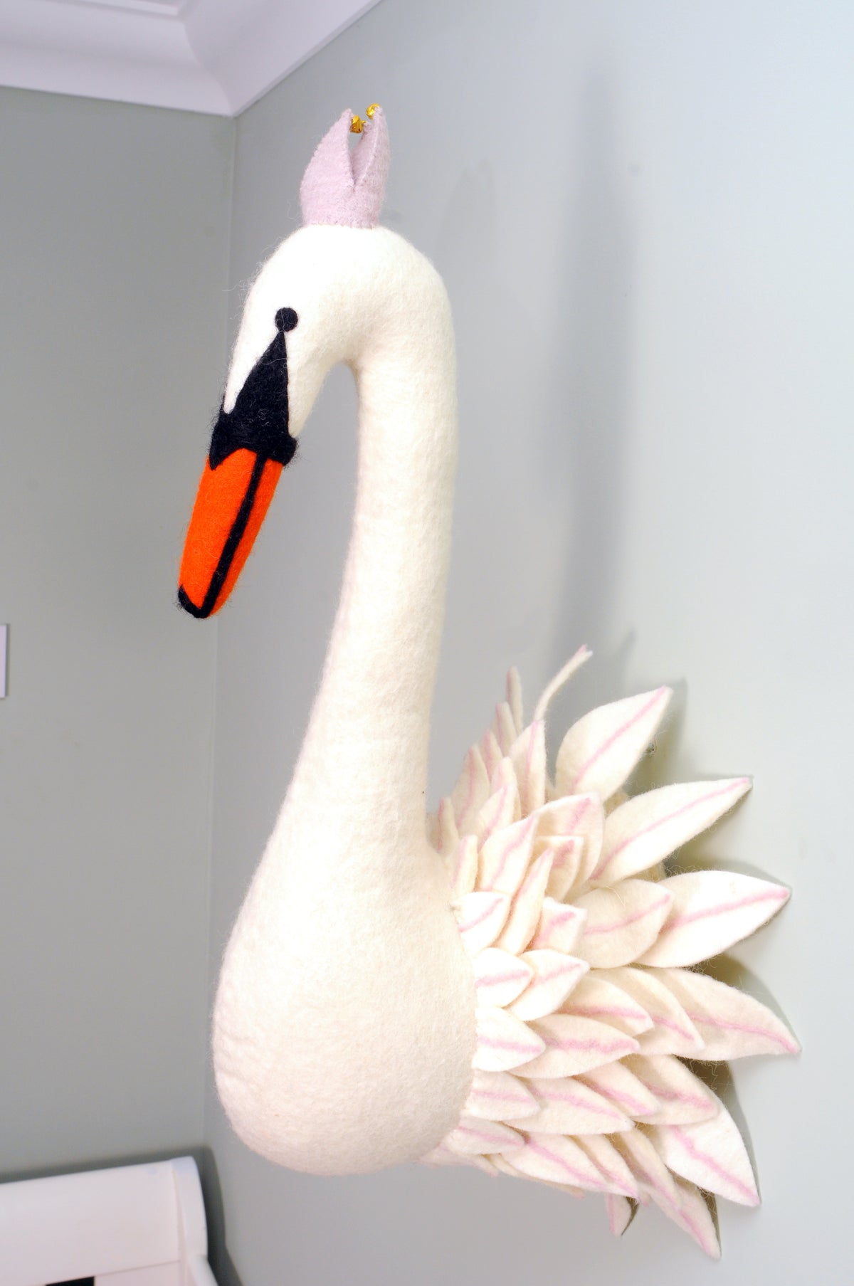 White felt swan wall décor with a pink crown and layered pink-tipped feathers