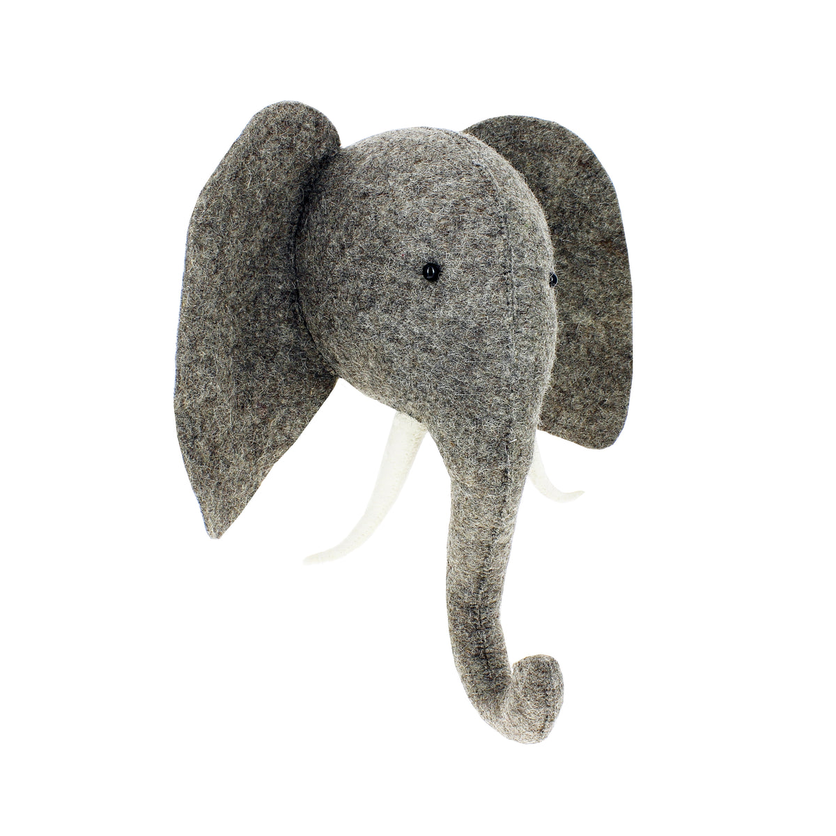 Side-angle view of the Fiona Walker medium grey elephant head wall décor, featuring textured wool felt, oversized ears, an elongated curved trunk and ivory tusks on a white background.