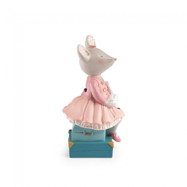 Side profile of the Moulin Roty The Little Dance School money box, showing a mouse in a pink ballerina dress holding a white swan, with a teal-blue suitcase-style base.