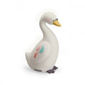 White swan-shaped night light with a yellow beak, dark feet and delicate pink and blue feather details on its side