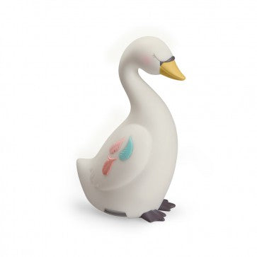 White swan-shaped night light with a yellow beak, dark feet and delicate pink and blue feather details on its side