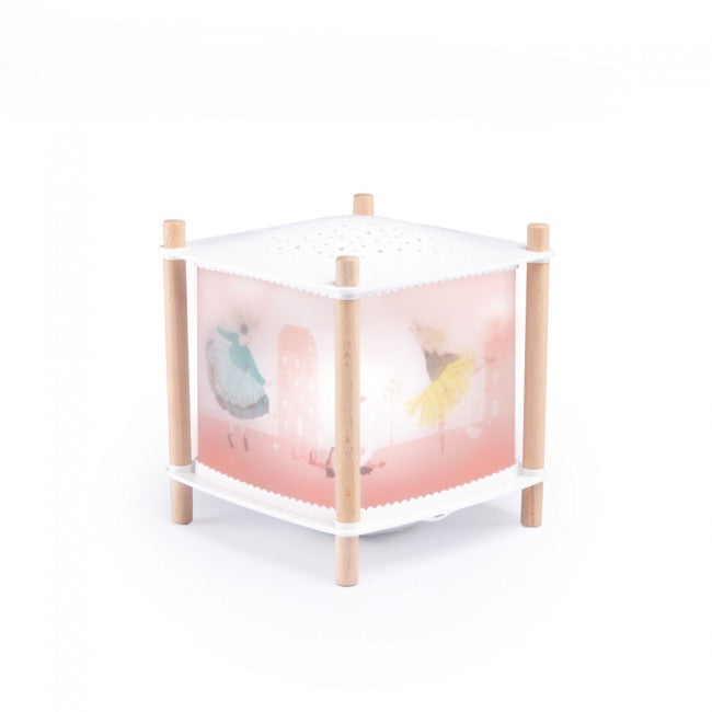 The Little Dance School USB lantern with translucent pink panels featuring dancing ballerinas, a white top and base, and light wooden legs on a white background