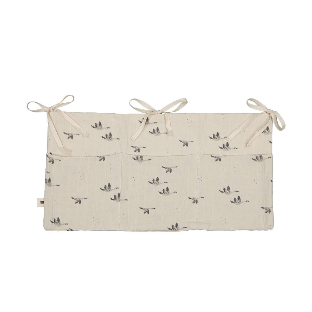 Mathilde Goose Natural cot storage organiser featuring three spacious pockets, a delicate grey goose print and cream fabric ties against a white background.