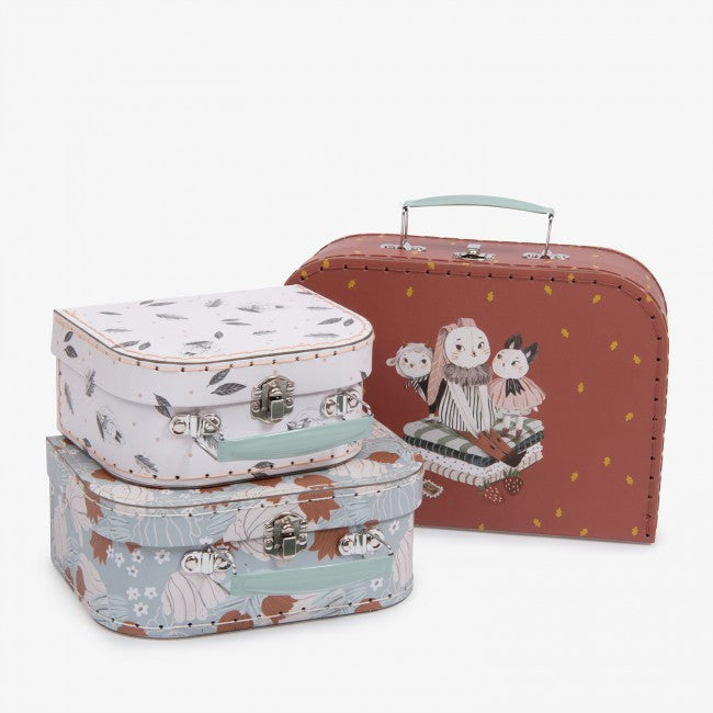 Three Moulin Roty Après la Pluie decorative storage cases in white, blue and plum designs displayed together on a white background