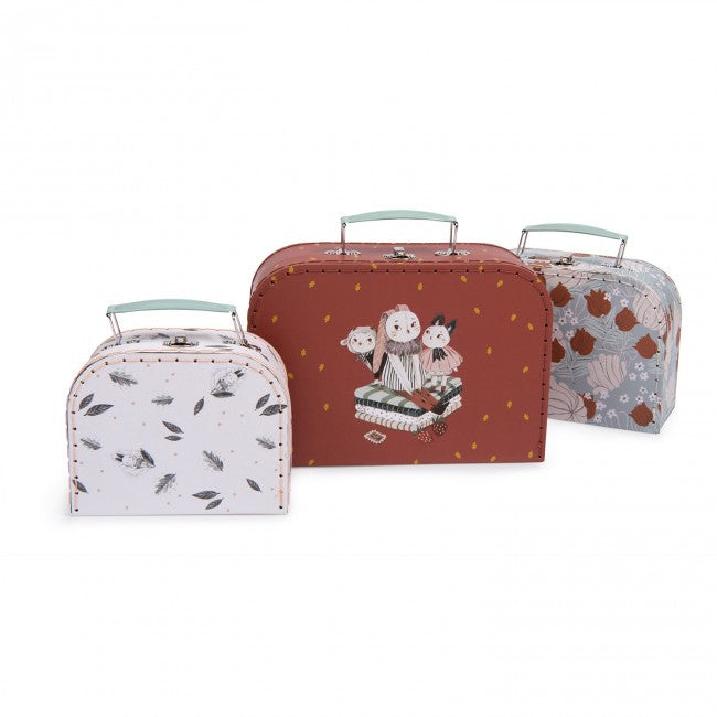 Three Moulin Roty Après la Pluie decorative storage cases in white, plum and blue designs displayed together on a white background