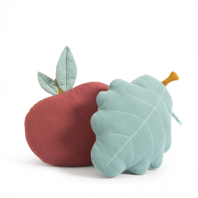 Turquoise oak leaf-shaped cushion with an ochre stem displayed beside a red apple-shaped cushion on a white background