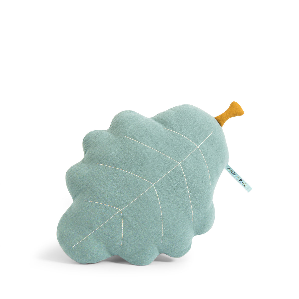 Turquoise oak leaf-shaped cushion with stitched leaf details and an ochre stem on a white background