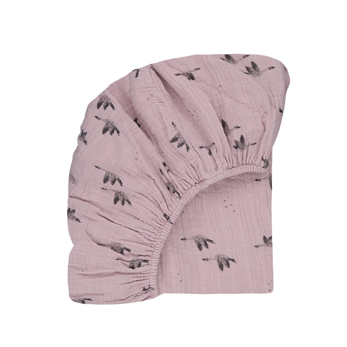 Close-up product view of the lilac goose-print fitted cot sheet, showing its elasticated edge and soft muslin texture against a white background.