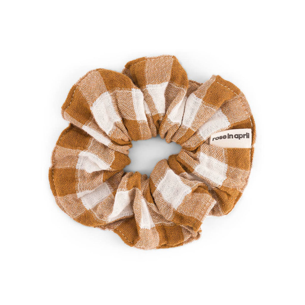 Vichy Caramel scrunchie featuring a warm caramel and cream gingham check pattern, made from cotton muslin and displayed against a white background.