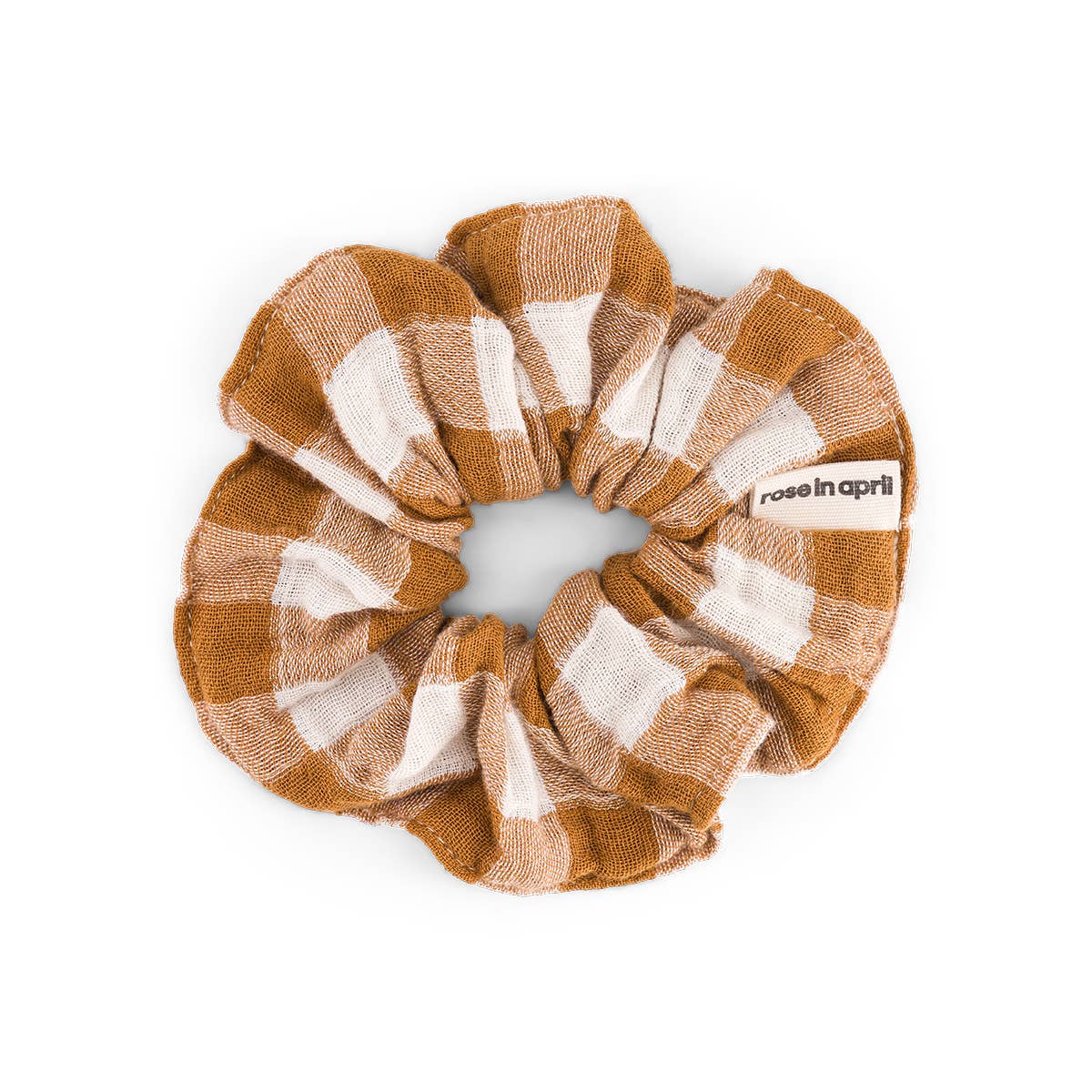 Vichy Caramel scrunchie featuring a warm caramel and cream gingham check pattern, made from cotton muslin and displayed against a white background.